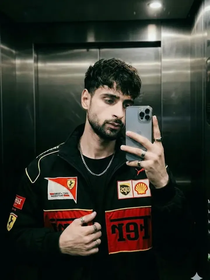 Confident bearded AI boyfriend Jules in an urban racing jacket